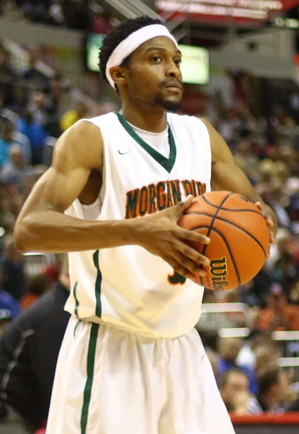 Marcus Jordan playing basketball in a white Morgan Park jersey, holding a basketball during a game.