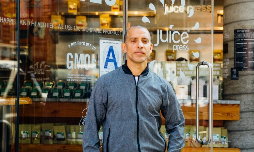 Marcus Antebi standing outside a Juice Press storefront