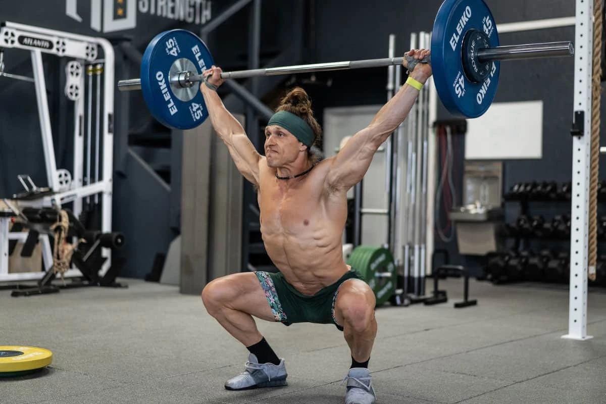 Marcus Filly lifting a barbell in a gym during a workout