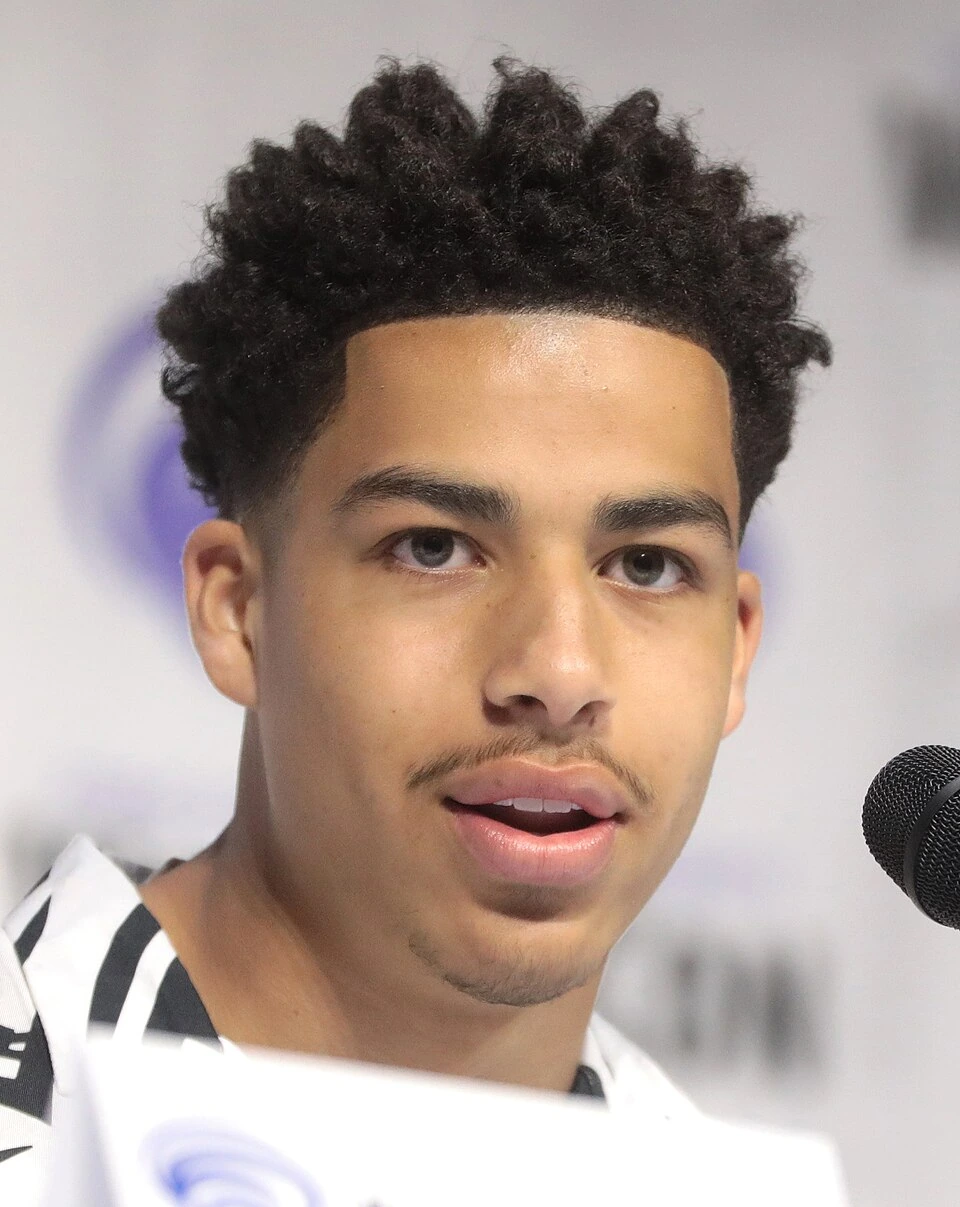 Marcus Scribner at a public event, speaking into a microphone
